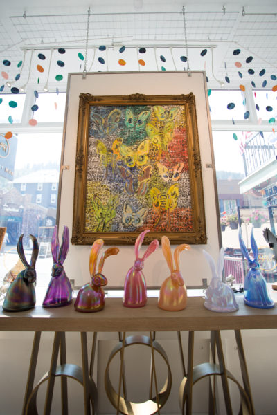 Glass bunnies rest under an oil painting by Hunt Slonem, "Polyphemus," 43" x 32"