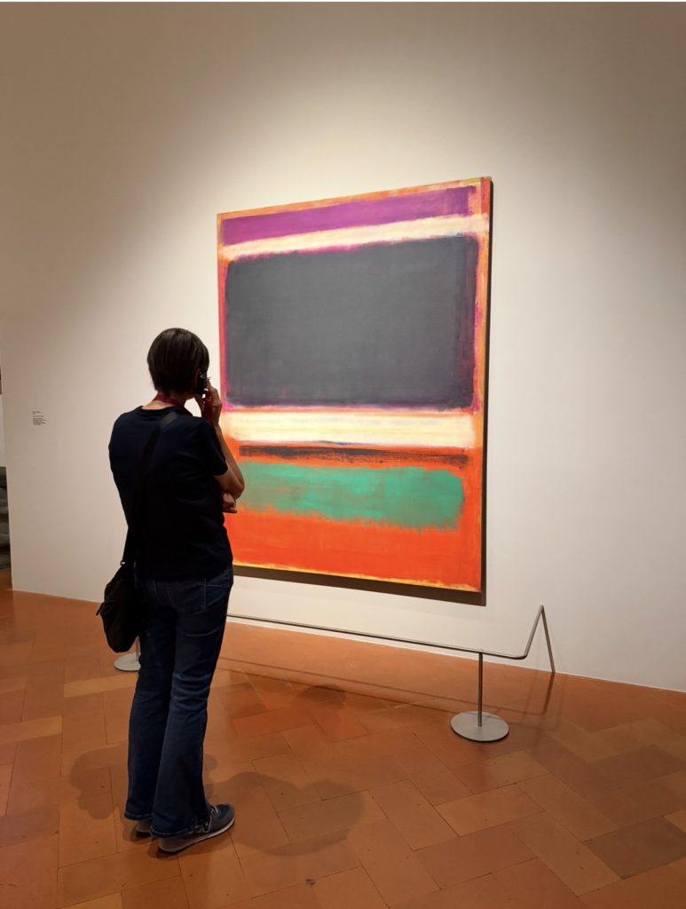 The exhibition's cover piece: the main cover painting featured on the official exhibition materials for the Rothko in Florence exhibition at Palazzo Strozzi is Mark Rothko, No. 3/No. 13 (1949). This work features deep, stacked horizontal bands of color, primarily magenta, black, and green on an orange background.